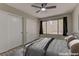 Bedroom with neutral tones, closet, ceiling fan, large window, and carpet, creating a cozy and serene atmosphere at 5710 E Tropicana Ave # 1216, Las Vegas, NV 89122