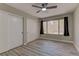 This bedroom features two closets, wood floors and a ceiling fan at 5710 E Tropicana Ave # 1216, Las Vegas, NV 89122