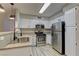 Clean kitchen featuring white cabinetry, stainless steel appliances, and wood floors, blending style with functionality at 5710 E Tropicana Ave # 1216, Las Vegas, NV 89122