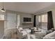 Bright living room with wood floors, neutral tones, a sliding glass door to the balcony, and contemporary furnishings at 5710 E Tropicana Ave # 1216, Las Vegas, NV 89122