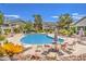 Enjoy swimming in this community pool with surrounding lounge chairs and tables at 5710 E Tropicana Ave # 1216, Las Vegas, NV 89122
