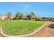 The backyard has green grass and mature trees at 5740 Winter Cherry St, Las Vegas, NV 89130