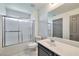 Well-lit bathroom features a shower with glass doors, a toilet, and a vanity with ample counter space at 5740 Winter Cherry St, Las Vegas, NV 89130