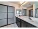 Bathroom featuring double sinks and a modern sliding glass shower door at 5740 Winter Cherry St, Las Vegas, NV 89130