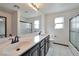 Bathroom with double sinks, large mirror, and glass-enclosed shower at 5740 Winter Cherry St, Las Vegas, NV 89130
