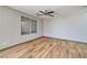 Cozy bedroom featuring wood-look flooring, a ceiling fan, and a window providing natural light at 5740 Winter Cherry St, Las Vegas, NV 89130