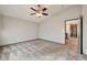 This spacious bedroom features a ceiling fan, neutral walls, plush carpeting, and access to other rooms at 5740 Winter Cherry St, Las Vegas, NV 89130