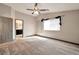 Neutral bedroom with a ceiling fan, carpet, and window letting in natural light at 5740 Winter Cherry St, Las Vegas, NV 89130