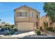 Charming two-story home featuring a two-car garage, complemented by a well-manicured front yard with decorative landscaping at 5740 Winter Cherry St, Las Vegas, NV 89130