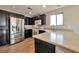 Well-equipped kitchen with dark cabinets, light countertops, stainless steel appliances, and a functional layout at 5740 Winter Cherry St, Las Vegas, NV 89130