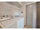 This laundry room features a washer, dryer, and convenient overhead shelving for storage and organization at 5740 Winter Cherry St, Las Vegas, NV 89130