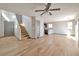 Bright living room with wood-look flooring and a modern ceiling fan, offering a seamless transition to the kitchen at 5740 Winter Cherry St, Las Vegas, NV 89130