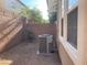 Cozy backyard with rock landscaping, enclosed by a brick wall, featuring an AC unit and small tree at 6255 W Arby Ave # 239, Las Vegas, NV 89118