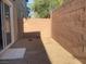 Private backyard featuring rock landscaping, enclosed by a brick wall, and a small concrete patio at 6255 W Arby Ave # 239, Las Vegas, NV 89118