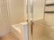 Bathroom showing a soaking tub with a glass door shower and access to the toilet and walk-in closet at 6255 W Arby Ave # 239, Las Vegas, NV 89118