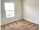 Well-lit bedroom with a window allowing natural light and neutral-toned patterned carpeting at 6255 W Arby Ave # 239, Las Vegas, NV 89118