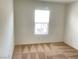Neutral bedroom bathed in light from a large window and patterned carpeting at 6255 W Arby Ave # 239, Las Vegas, NV 89118