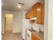 Kitchen featuring wood cabinets, neutral countertops, and white appliances at 6255 W Arby Ave # 239, Las Vegas, NV 89118