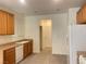 Well-lit kitchen features wood cabinets, white appliances, and neutral countertops at 6255 W Arby Ave # 239, Las Vegas, NV 89118