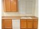 Close up of the kitchen with a large sink and wooden cabinets at 6255 W Arby Ave # 239, Las Vegas, NV 89118