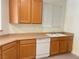 Kitchen area highlighting wood cabinets, neutral countertops, and modern appliances at 6255 W Arby Ave # 239, Las Vegas, NV 89118