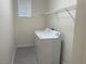 Bright laundry room with a white washer and dryer and wire rack at 6255 W Arby Ave # 239, Las Vegas, NV 89118