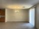 Spacious living area, featuring gray floors and an elegant chandelier at 6255 W Arby Ave # 239, Las Vegas, NV 89118