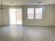 Open-concept living room showcasing sliding glass doors and generous natural light at 6255 W Arby Ave # 239, Las Vegas, NV 89118