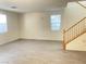 Bright living room with laminate flooring next to the stairs at 6255 W Arby Ave # 239, Las Vegas, NV 89118