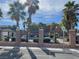 Inviting community pool area with palm trees, lounge chairs, and accessible reserved parking spots at 6255 W Arby Ave # 239, Las Vegas, NV 89118