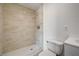 A shower room has decorative tiling on the shower walls and white tiling on the floor, as well as updated fixtures at 629 N 16Th St, Las Vegas, NV 89101