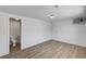 This is a bedroom with wood floor, white walls and ceilings, and a pair of doors leading to the outside and the bathroom at 629 N 16Th St, Las Vegas, NV 89101