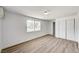 A bright bedroom with wood floors and light walls features a pair of windows and access to a large closet at 629 N 16Th St, Las Vegas, NV 89101