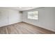 An empty bedroom with a window, light wood-look flooring, and stark white walls is ready for furniture and decoration at 629 N 16Th St, Las Vegas, NV 89101