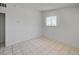 Bedroom with neutral walls and tiled floor features a window for natural light at 629 N 16Th St, Las Vegas, NV 89101