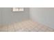 Bedroom with neutral walls and tiled floor features a window for natural light at 629 N 16Th St, Las Vegas, NV 89101