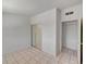 Bedroom with sliding closet doors and neutral color scheme features tiled flooring at 629 N 16Th St, Las Vegas, NV 89101