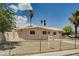 Charming single-story home with desert landscaping, fenced yard, and mature palm trees at 629 N 16Th St, Las Vegas, NV 89101