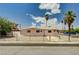Inviting single-story home with a fenced yard, mature landscaping and an expansive front lawn at 629 N 16Th St, Las Vegas, NV 89101
