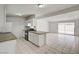 Well-lit kitchen and living area featuring bright, neutral tones, tile flooring, and ample counter space at 629 N 16Th St, Las Vegas, NV 89101