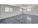 Spacious living room with tile flooring, multiple windows, and ceiling fans at 629 N 16Th St, Las Vegas, NV 89101