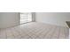 An open living space features light tile flooring and bright walls, plus a sliding glass door to the backyard at 629 N 16Th St, Las Vegas, NV 89101