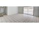 The light and airy living space features large tile flooring, white walls, and a sliding glass door to the back yard at 629 N 16Th St, Las Vegas, NV 89101