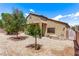 Rear exterior featuring desert landscaping, covered patio, and ample sunlight at 6617 Johnny Love Ln, North Las Vegas, NV 89086