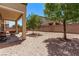 Backyard with rock landscaping, mature trees, and a covered patio at 6617 Johnny Love Ln, North Las Vegas, NV 89086