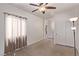 Bedroom featuring neutral carpeting, a ceiling fan, and a large window at 6617 Johnny Love Ln, North Las Vegas, NV 89086