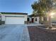 Single-story home features a two-car garage, easy-care landscaping, and covered front entry at 6617 Johnny Love Ln, North Las Vegas, NV 89086