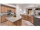 Well-equipped kitchen with granite countertops, modern appliances, and eat-in island with sink at 6617 Johnny Love Ln, North Las Vegas, NV 89086