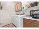 Laundry room with front loading washer and dryer and a countertop at 6617 Johnny Love Ln, North Las Vegas, NV 89086