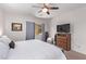 Inviting main bedroom with ceiling fan, dresser with TV, and natural light from the window at 6617 Johnny Love Ln, North Las Vegas, NV 89086